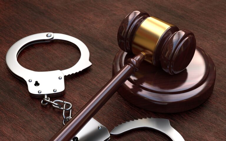 A Gavel and Handcuffs on a Table